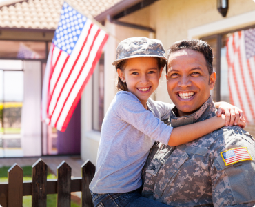 A military father and daughter outside smiling in appreciation of their military discount.