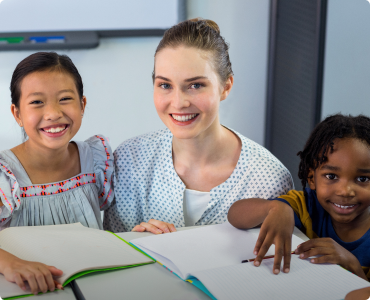 A teacher and two students pose for the camera to represent discounts for teachers.